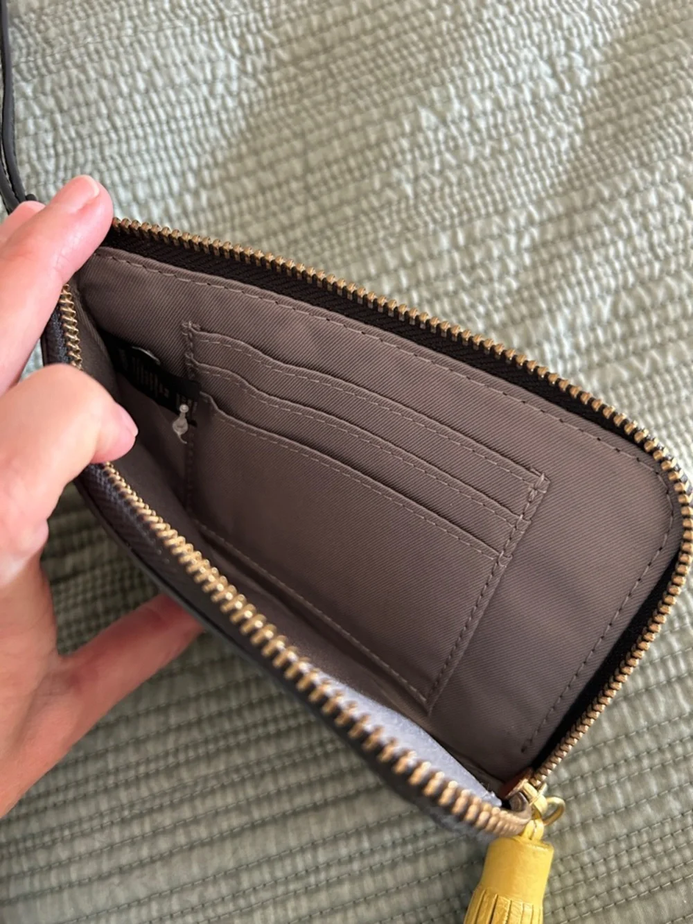Fossil Tara Black Pebbled Leather Wristlet with Yellow Tassel Accent